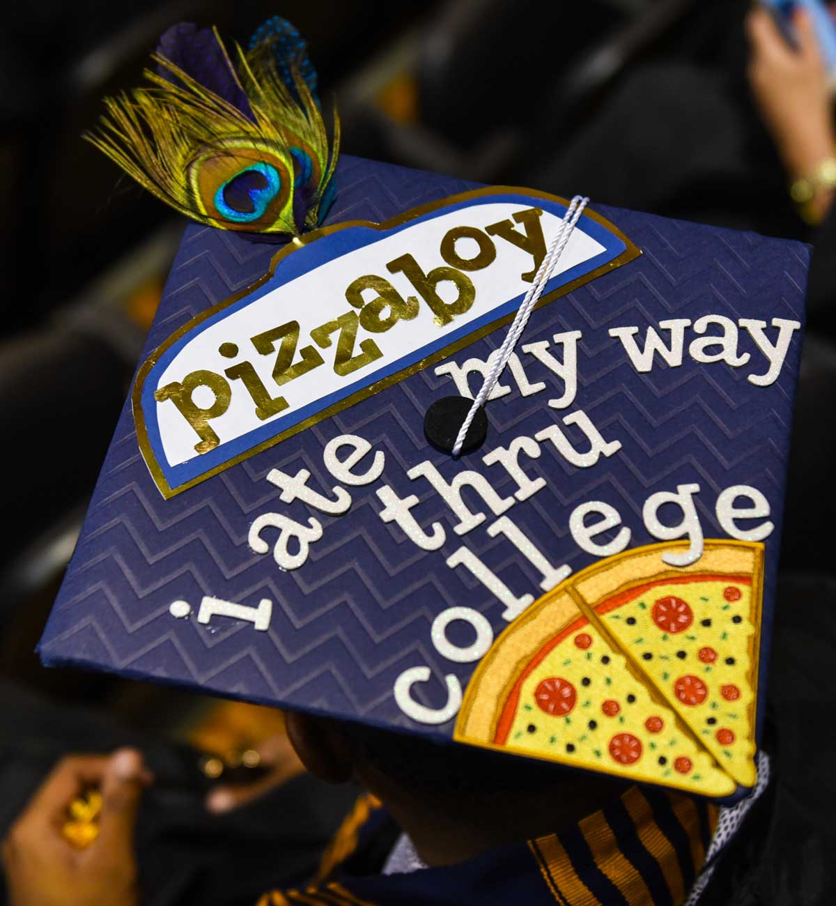 Grad cap decorated with text: Pizzaboy I ate my way thru college