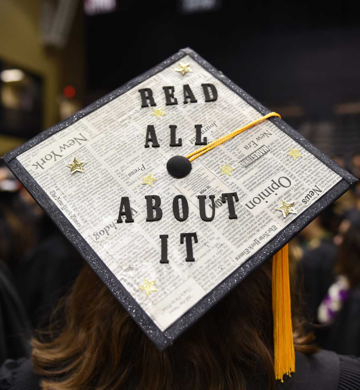 Grad cap decorated with newspaper and text: Read all about it