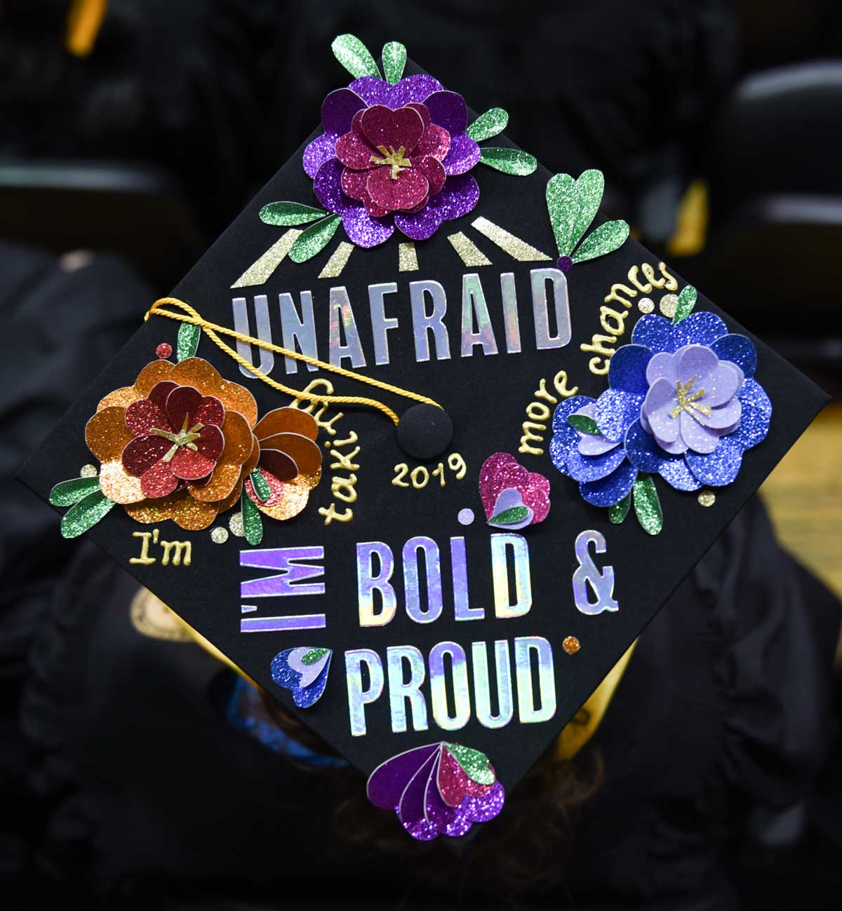 Grad cap decorated with text: Unafraid I'm bold & proud