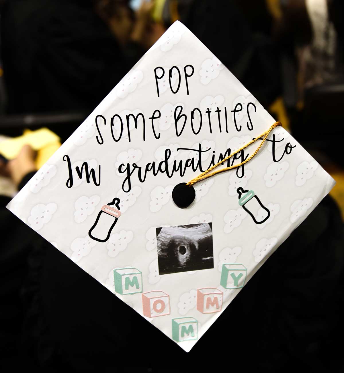 Grad cap decorated with text: Pop some bottles, I'm graduating to Mommy
