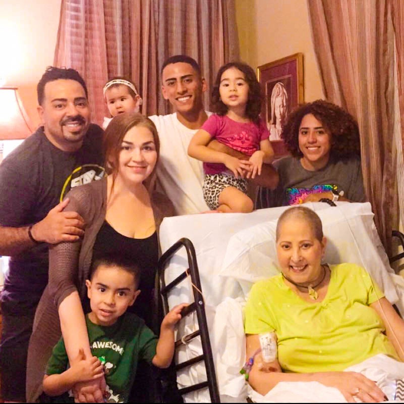 Maribel Ortiz-Pina's eldest son Pedro Morrero (left) and his family visit his mother. Ortiz-Pina's two other children, Julian (center) and Julisa Pina (right), are also pictured here.