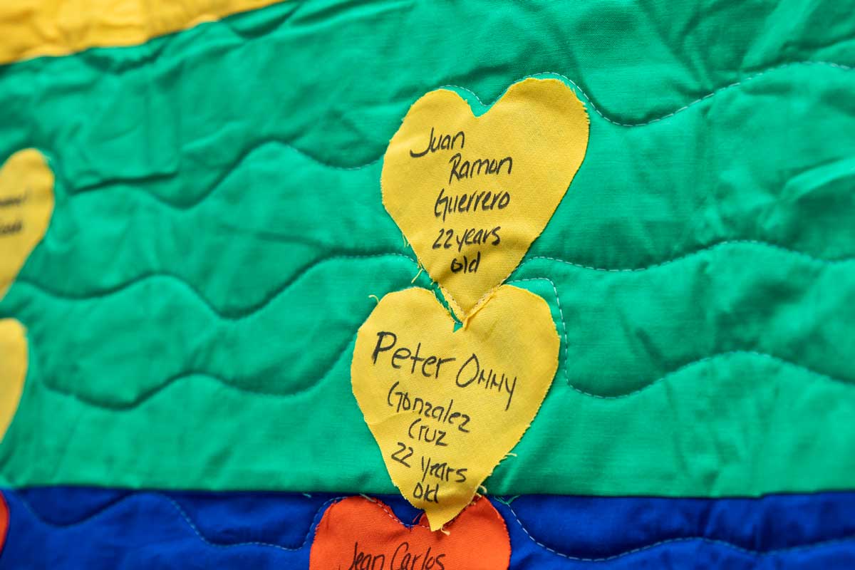 yellow hearts stitched on a green and blue quilt