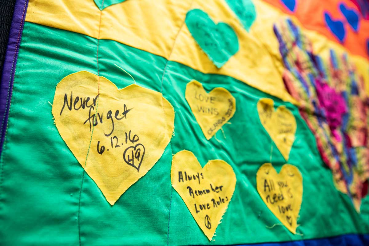 yellow hearts stitched on green quilt fabric