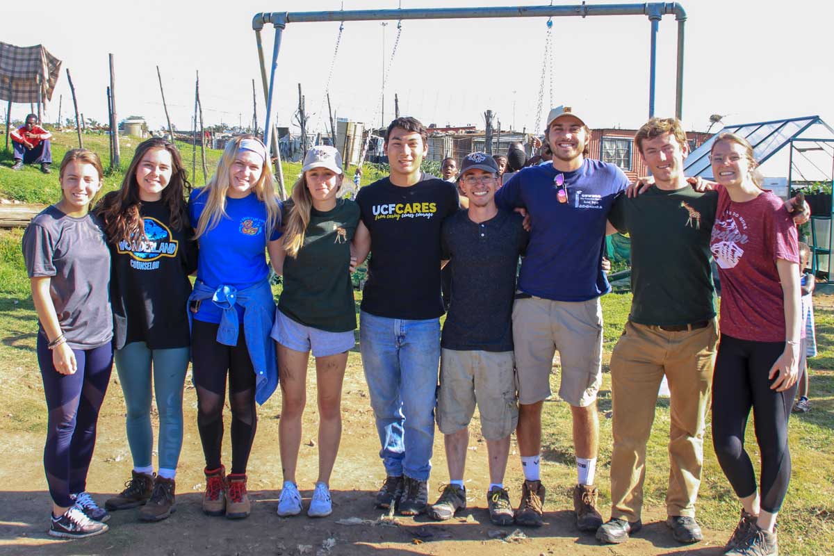 Group of UCF students pose in field