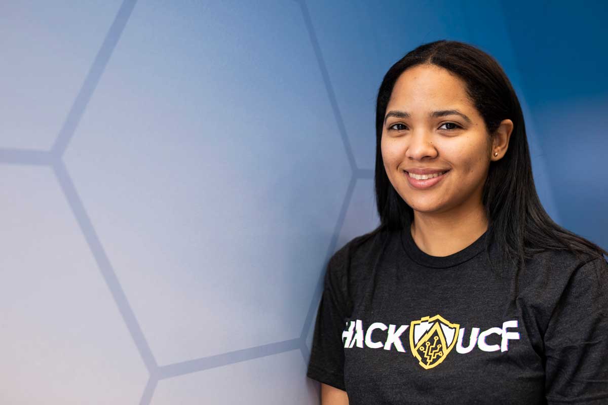 Female with dark hair wearing a Hack UCF black T shirt