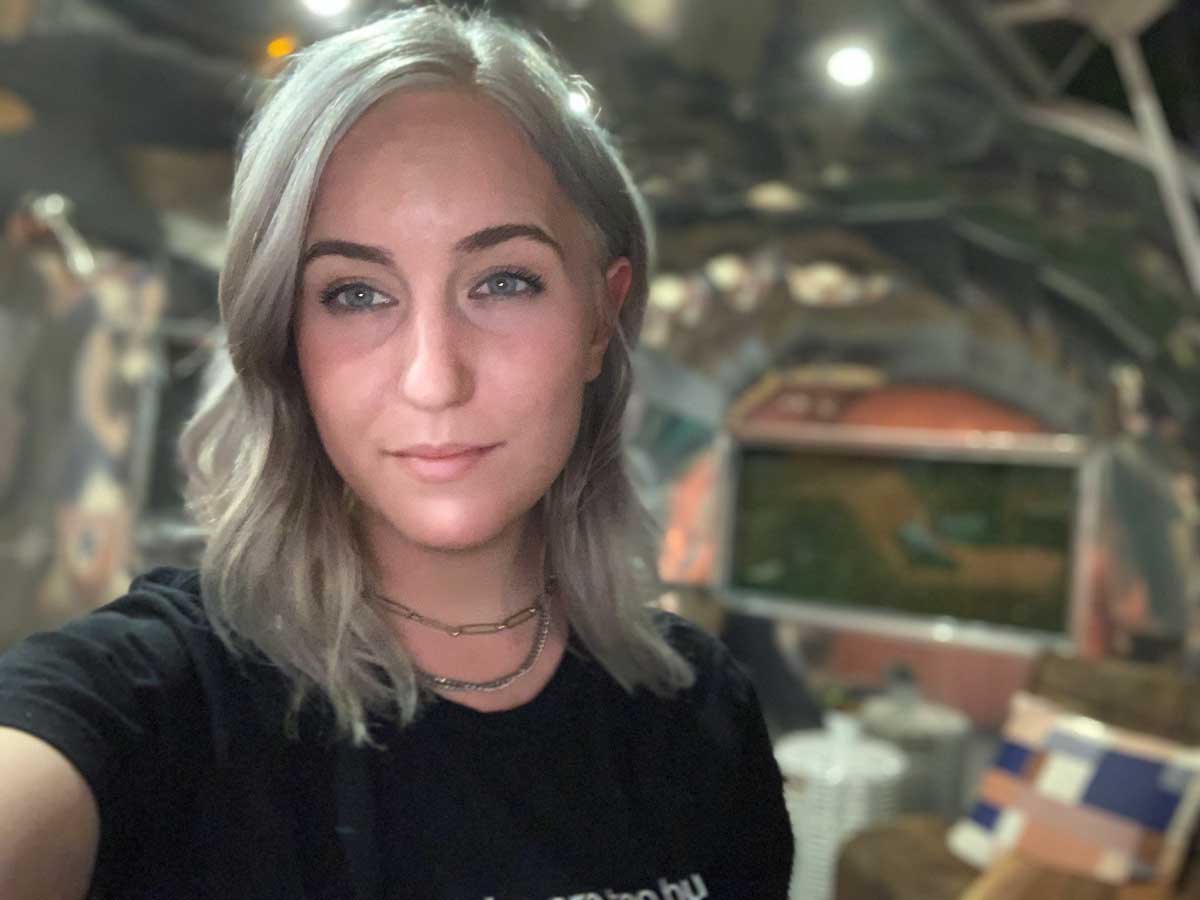 Blonde-gray haired female wearing black T shirt