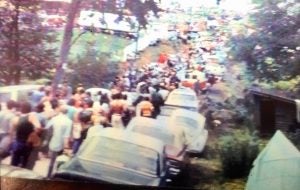 line of cars and people at Woodstock