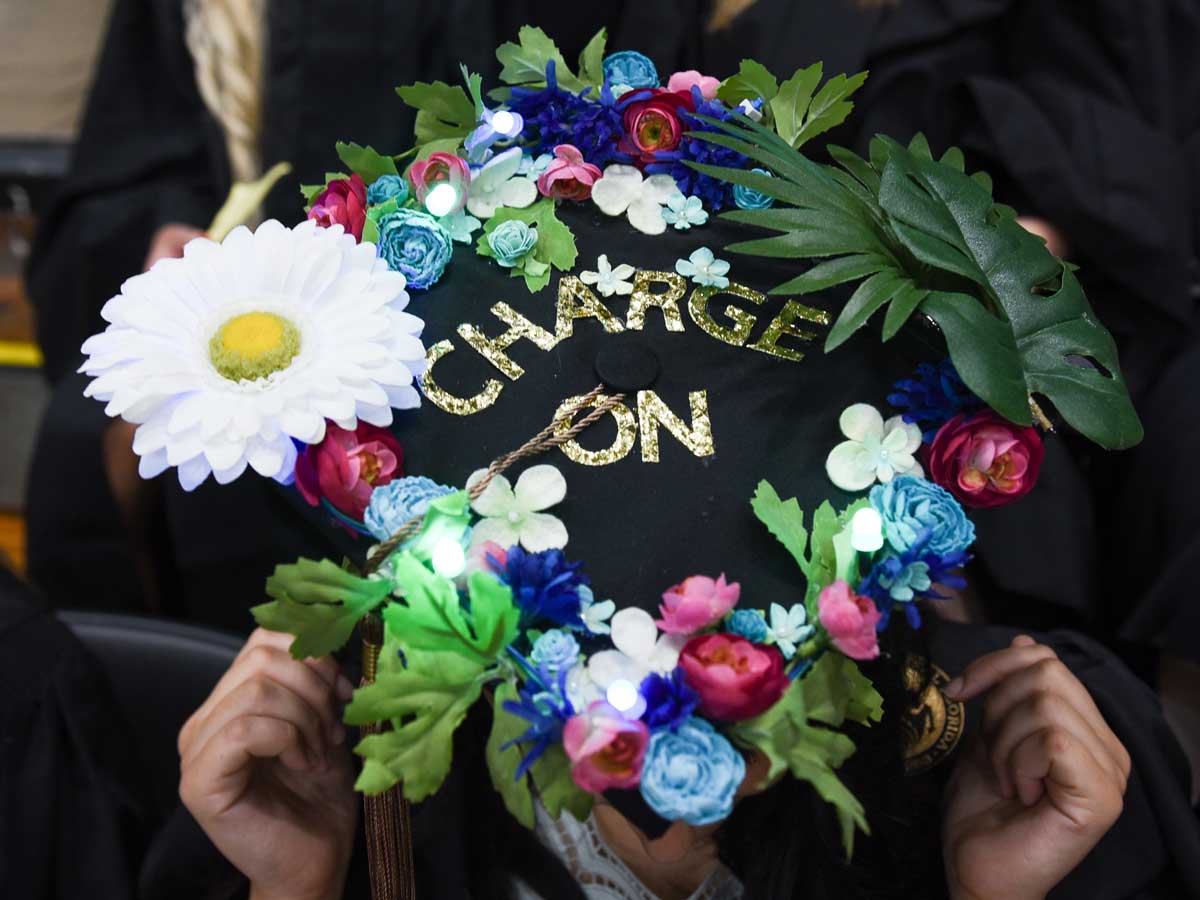 decorated grad cap with flowers: Charge On