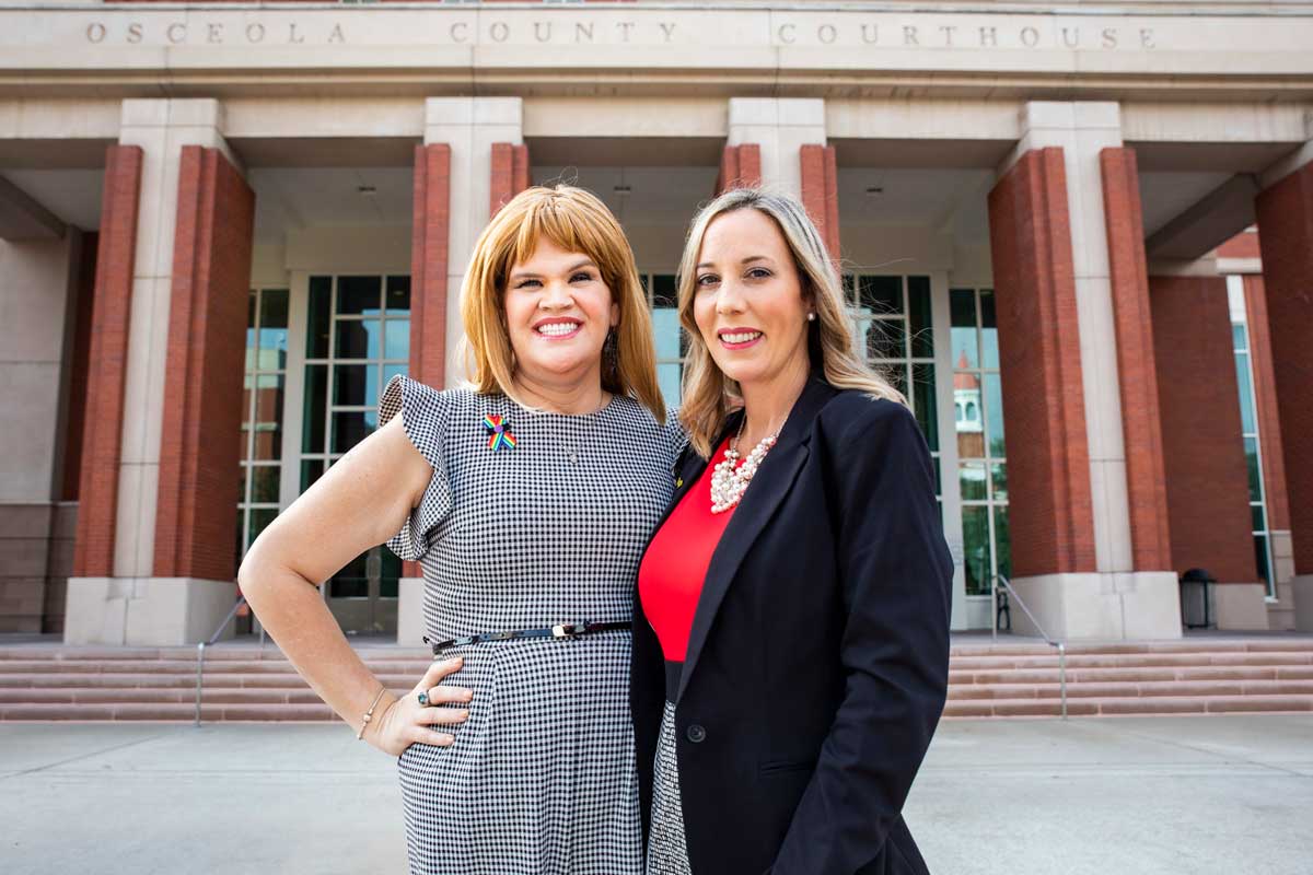 Juleigh Mayfield and Irene Pons stand in front of Osceola County Courthouse