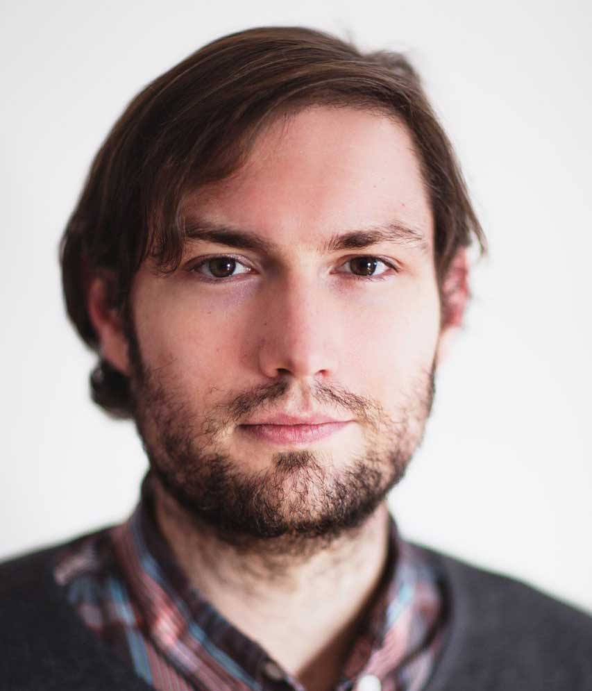 headshot of brunette man with beard