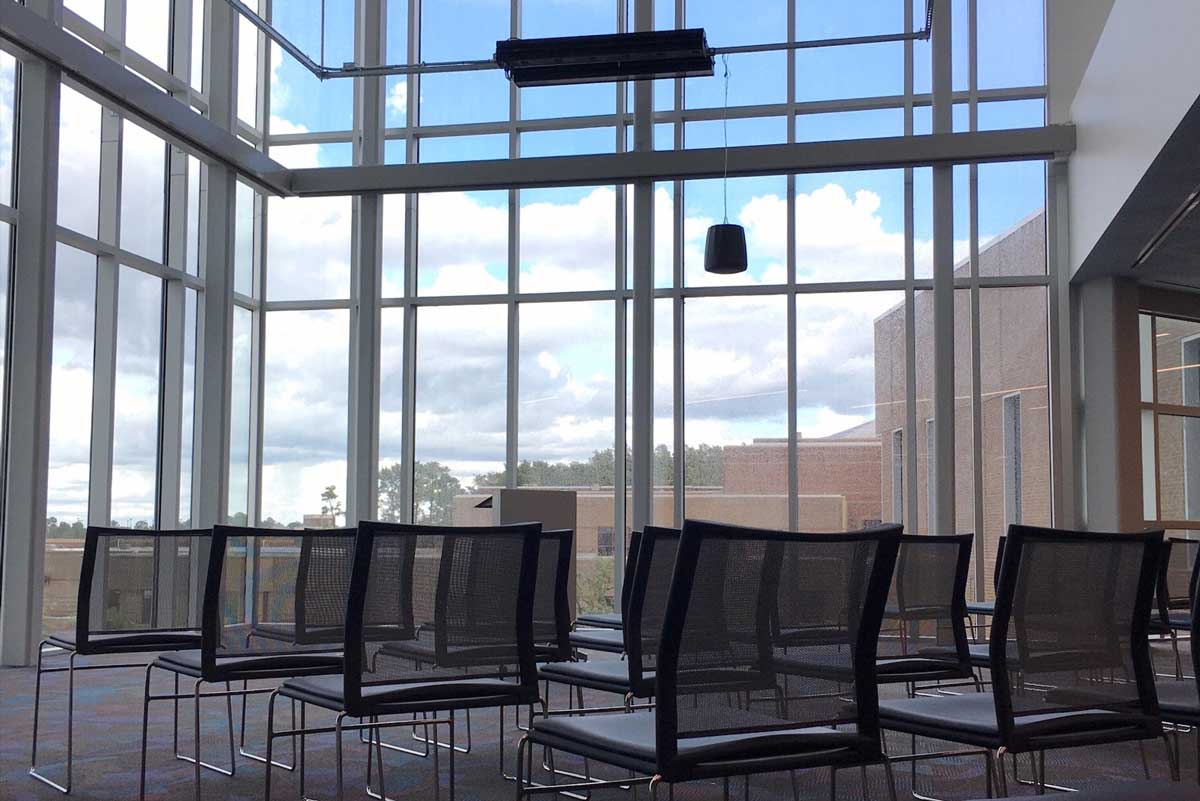 chairs aligned in rows in front of class windows