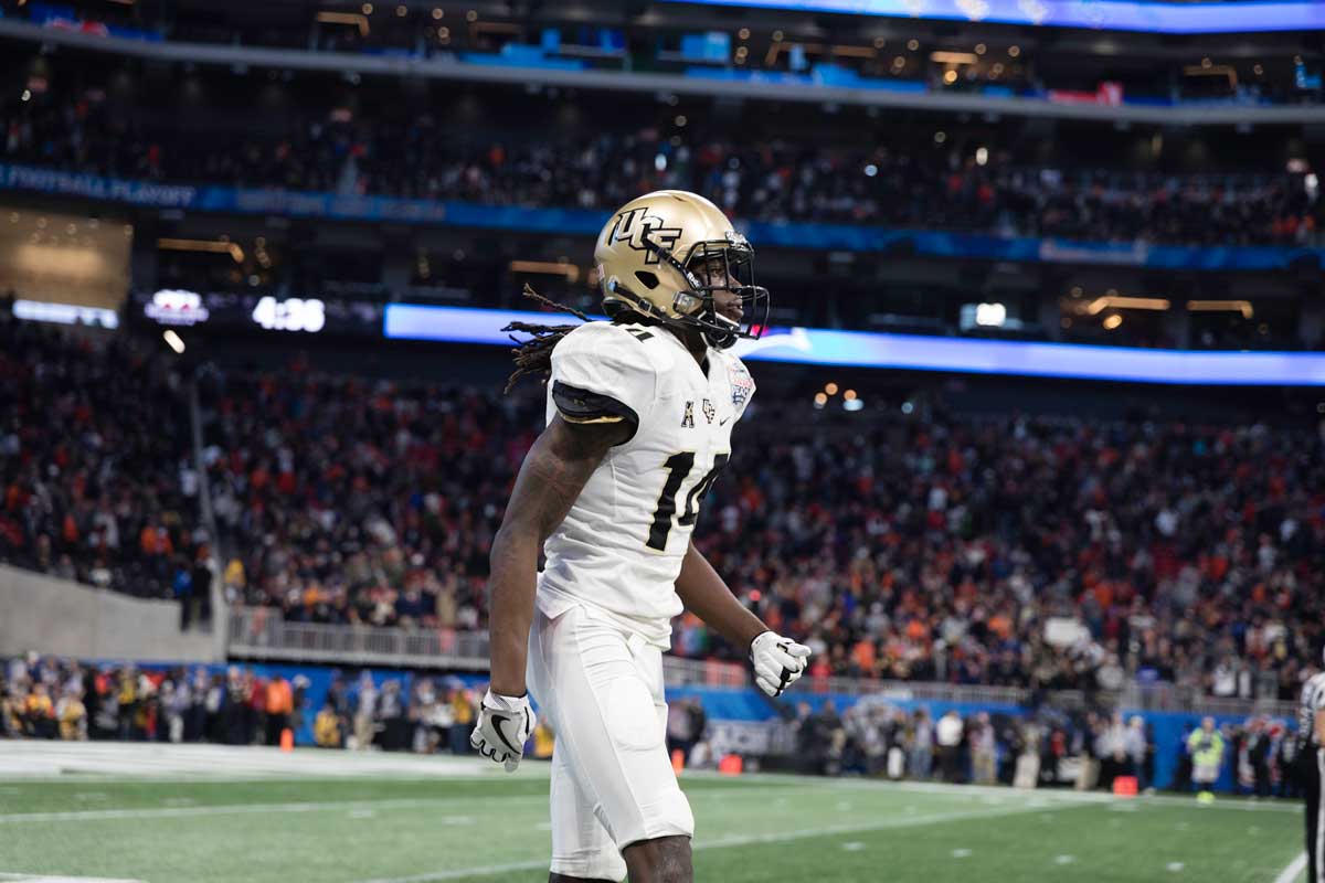 Nevelle Clarke in white football uniform and gold helmet