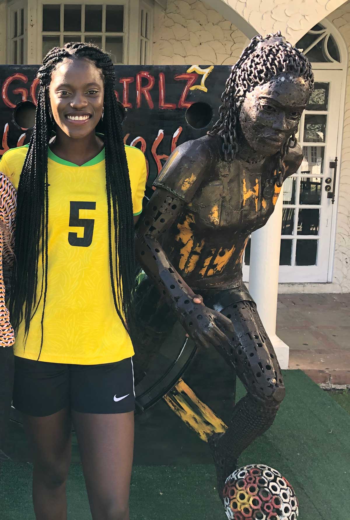 Konya Plummer stands next to statue in her likeness