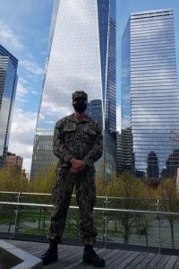 Jason A. Duprat ’09BSN poses for a photo near the 9/11 Memorial and Museum in New York City