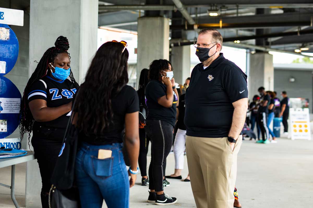 UCF President Alexander N. Cartwright talks with students