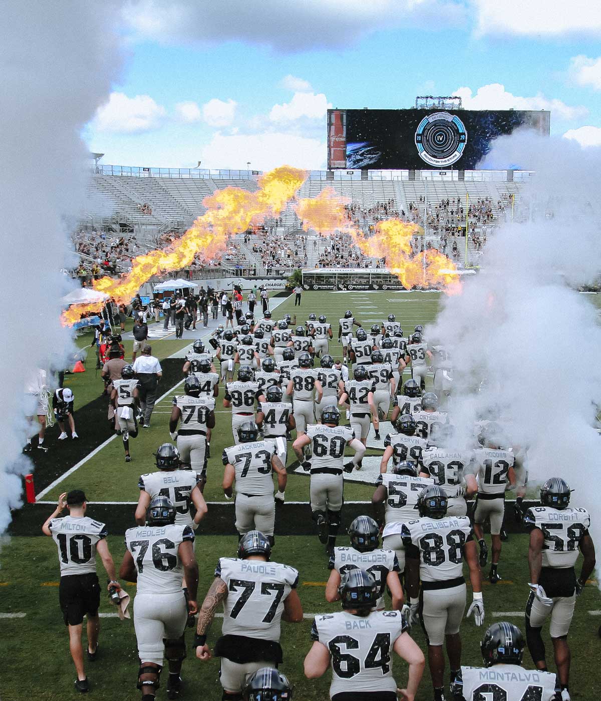 UCF football team runs onto the field with smoke and fire tunnel