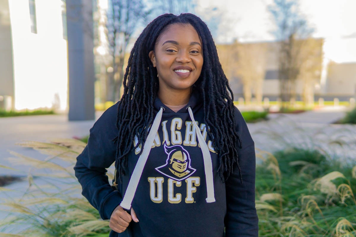 Oneisha Eugene wears a UCF hoodie while smiling.