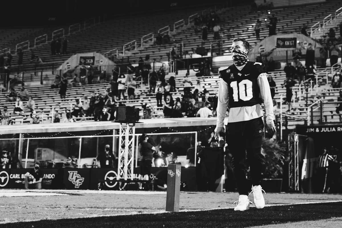 McKenzie Milton in #10 uniform looks out at field at the Bounce House