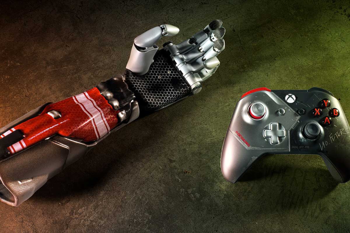 Red and silver bionic arm next to Xbox controller