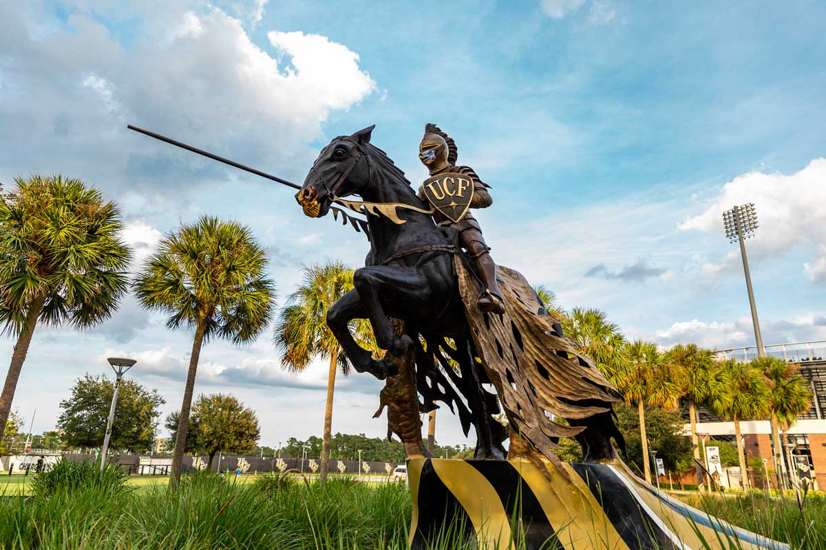 Charging Knight statue in front of the Bounce House wears a face mask