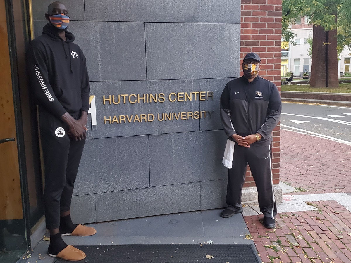 C. Keith Harrison and Tacko Fall stand outside of Harvard's Hutchins Center