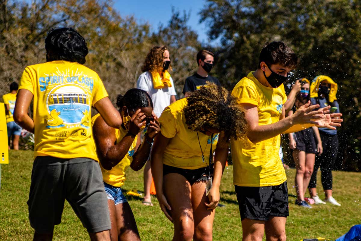 Group of four students get wet from water soakers