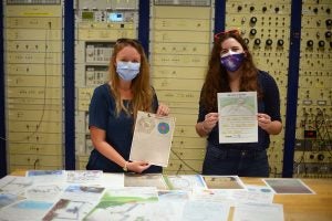 Allison Smith and Anna McGilvray with Arecibo Observatory hold letters of support from Orlando-area schoolchildren