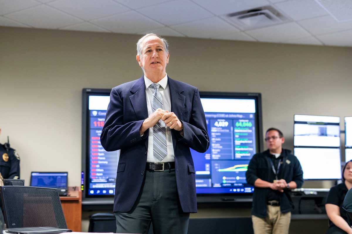 Michael Deichen addresses staff in conference room