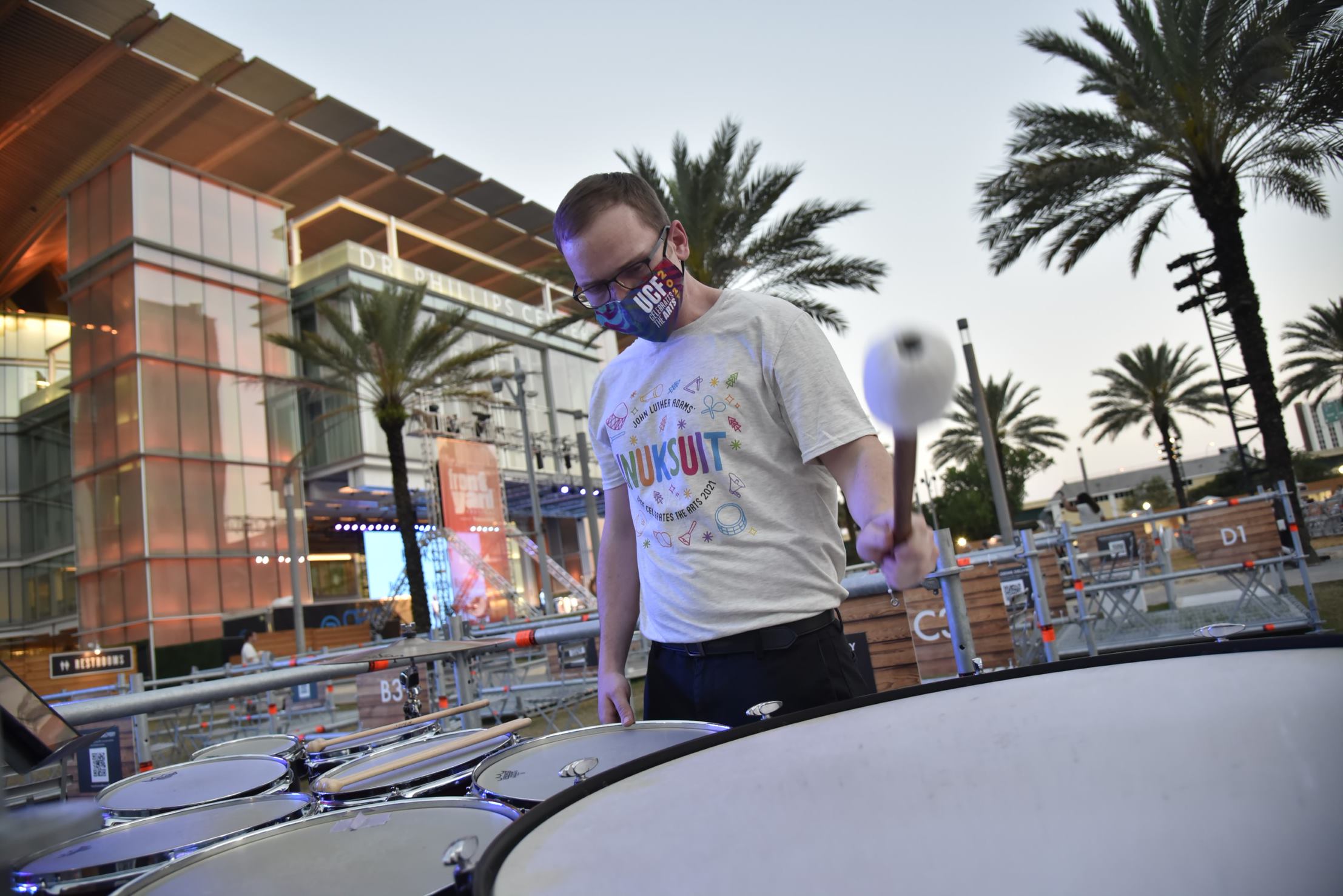 Student drums outside in front of Dr. Phillip Center