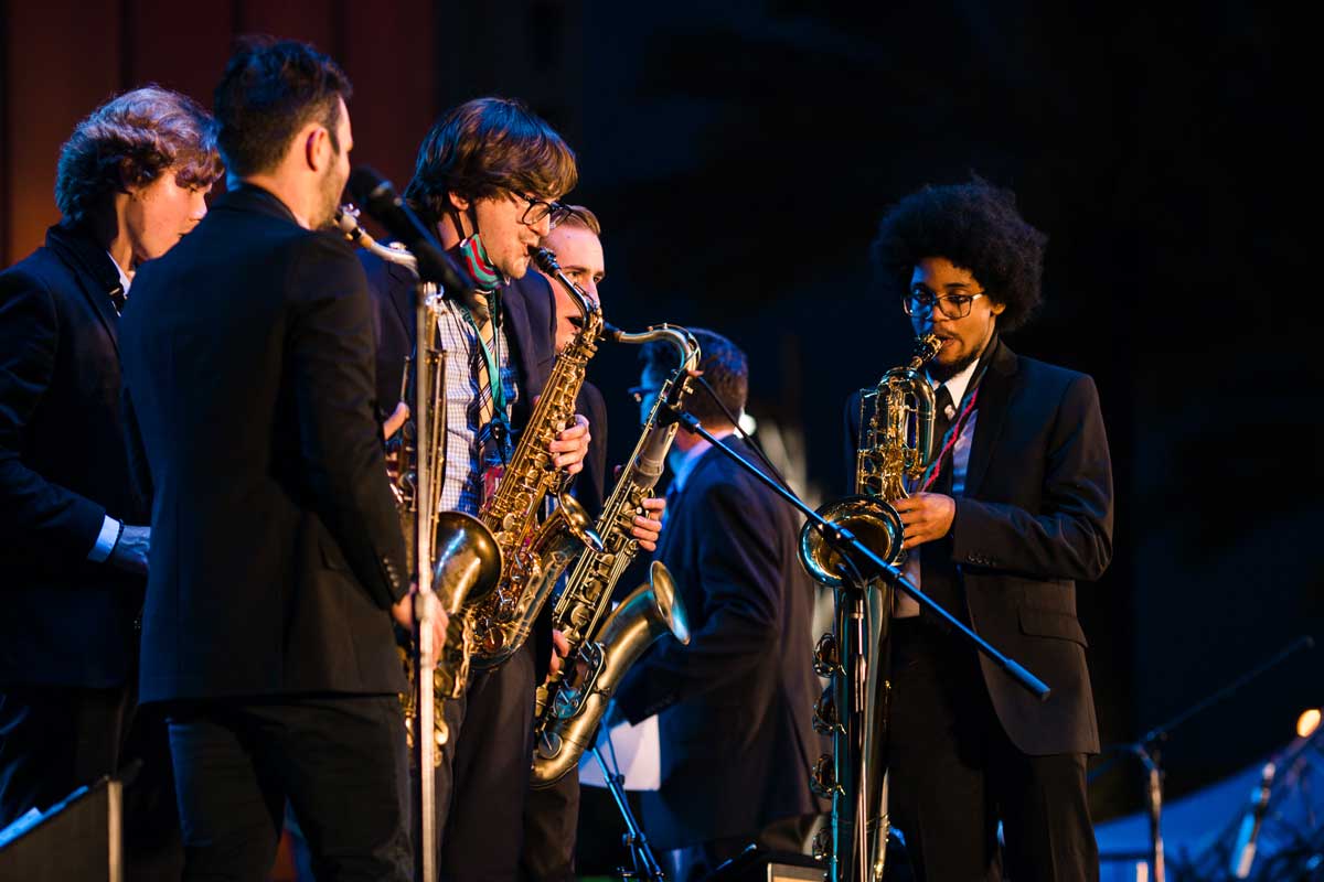 Group of saxophonists perform on stage