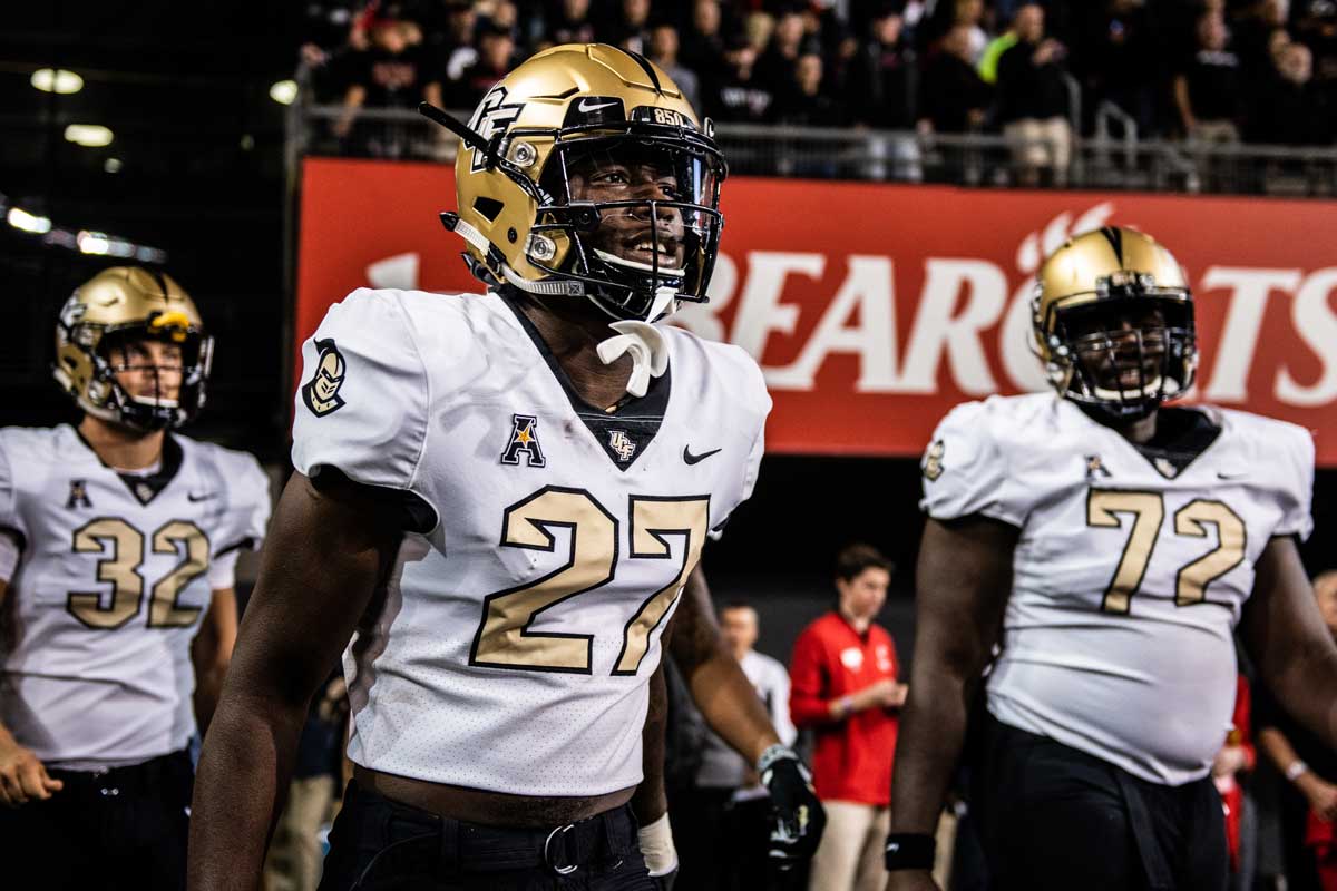 Richie Grant (#27) in gold helmet, white jersey with gold numbers 