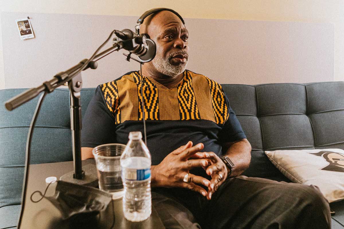 S. Kent Butler sits in front of a microphone on a stand 