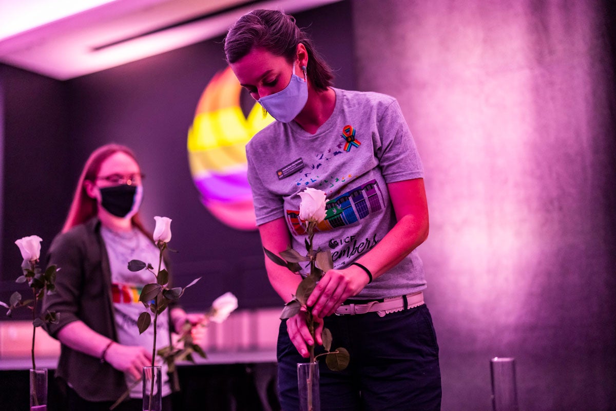 Woman places white rose ina vase