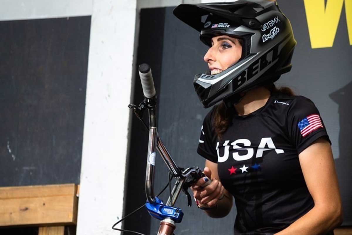 Chelsea Wolfe wearing helmet and holding handlebars