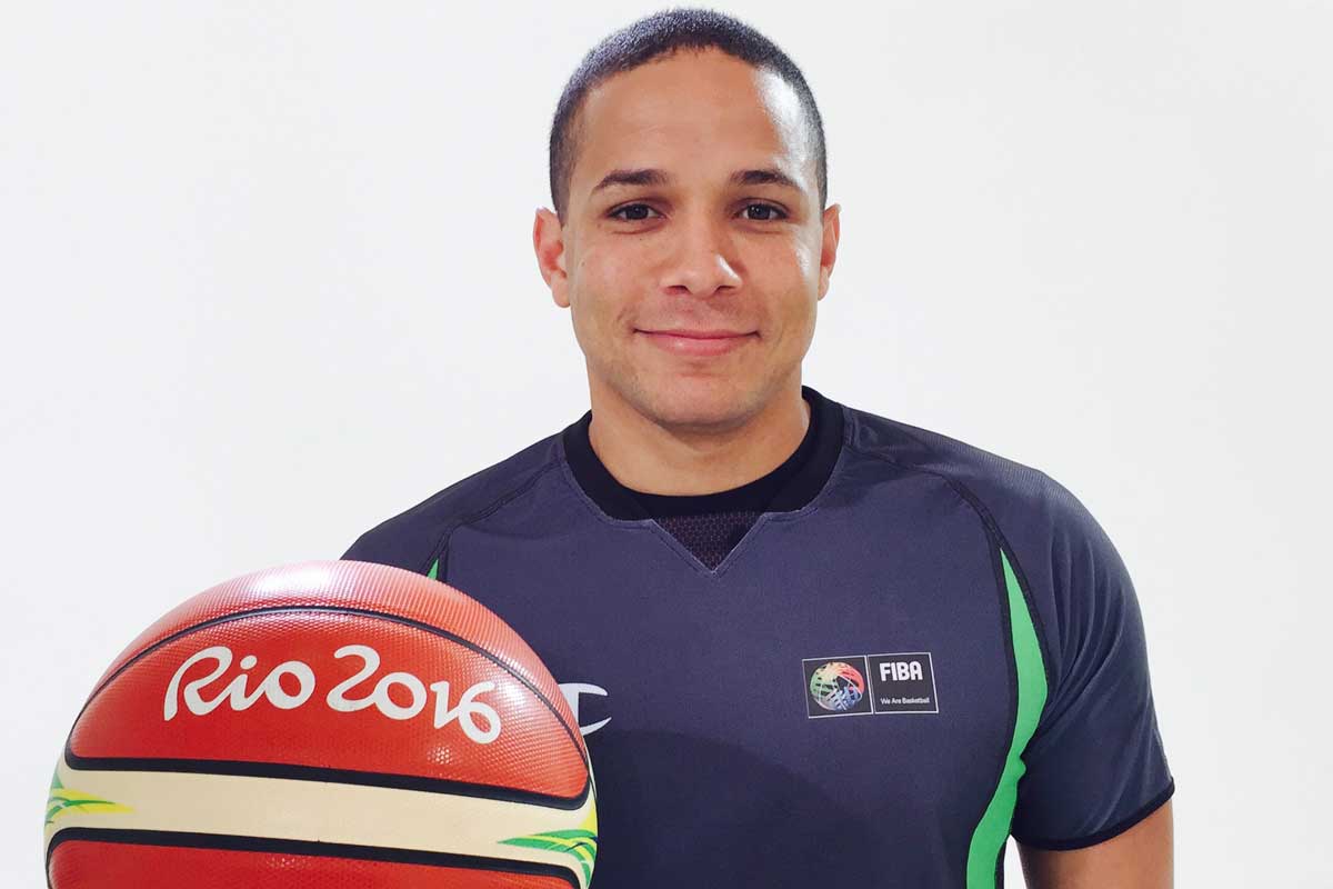 Steve Anderson holding a basketball that reads Rio 2016