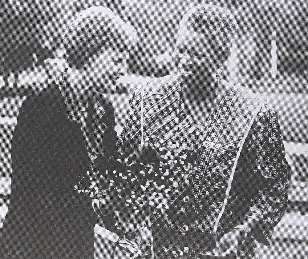 Martha Lue Stewart (right) presents Martha Hitt (left) with flowers following Hitt's speech at the opening ceremony of Diversity Week.