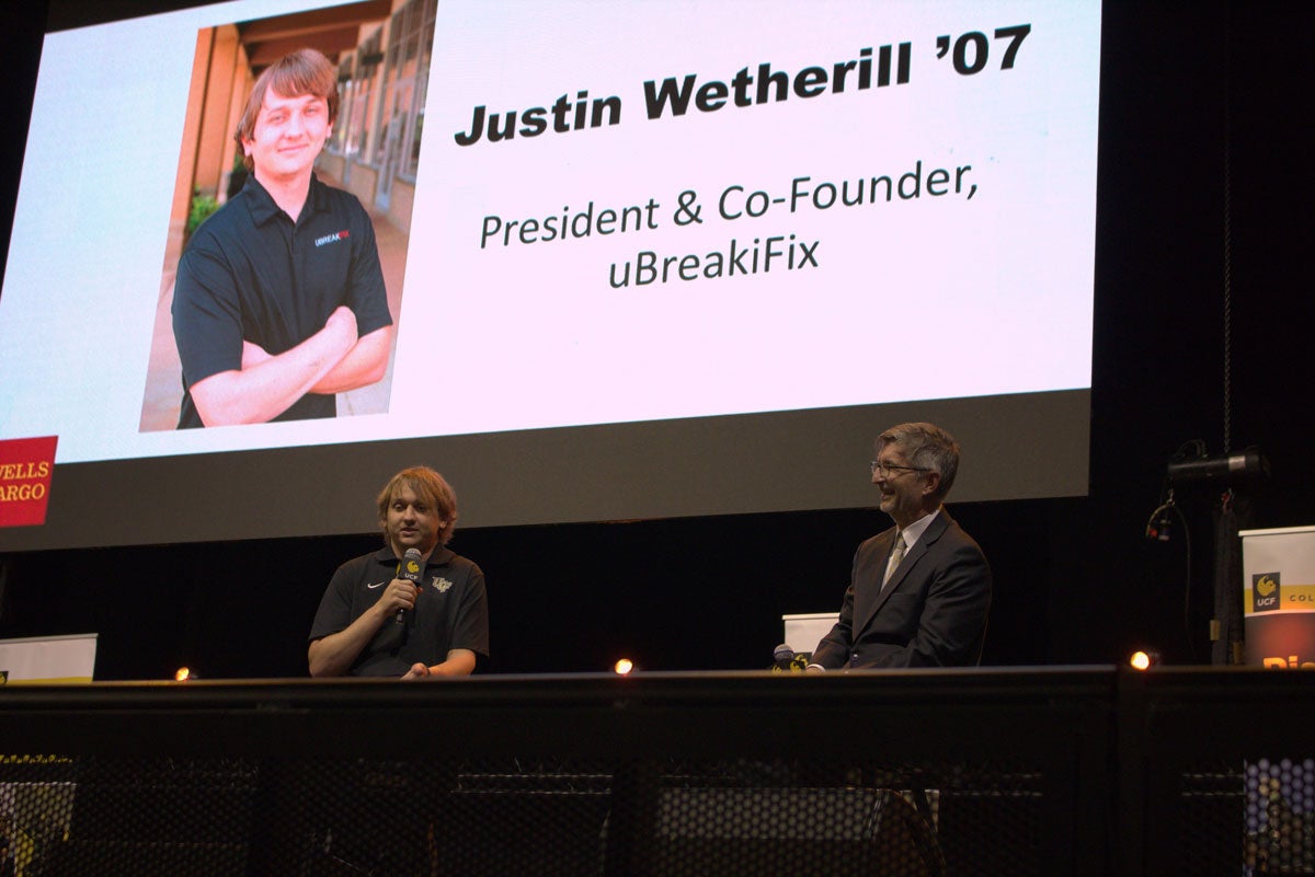 College of Business Dean Paul Jarley interviews UCF alum Justin Wetherill on stage