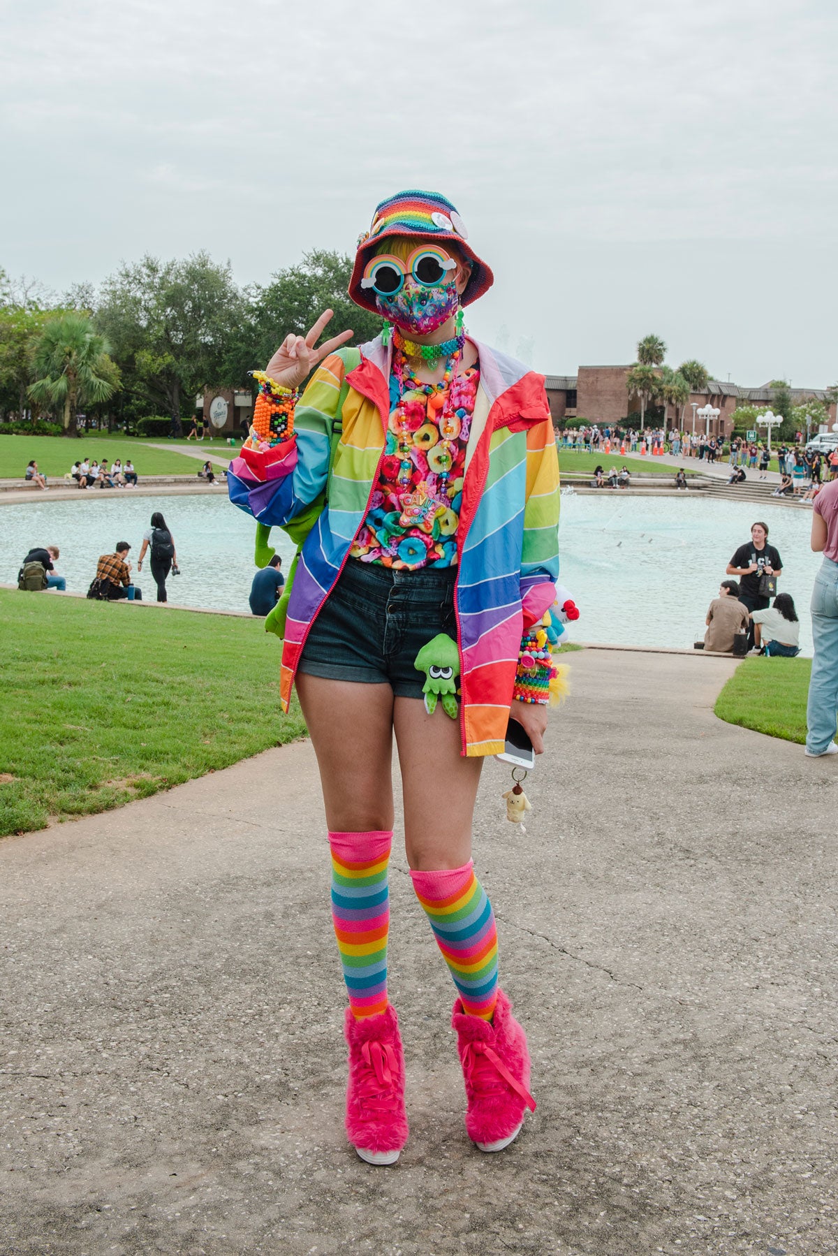 UCF student decked out in rainbow gear from head to toe near Reflecting Pond