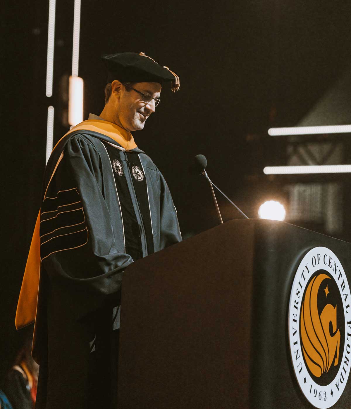 Darin Edwards speaks at podium with UCF seal 