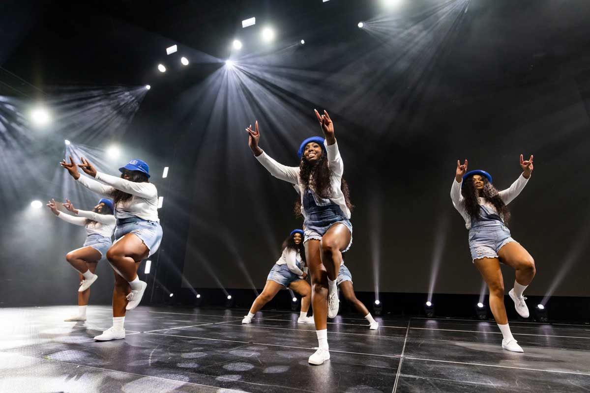 Female students choreographed dance on stage 