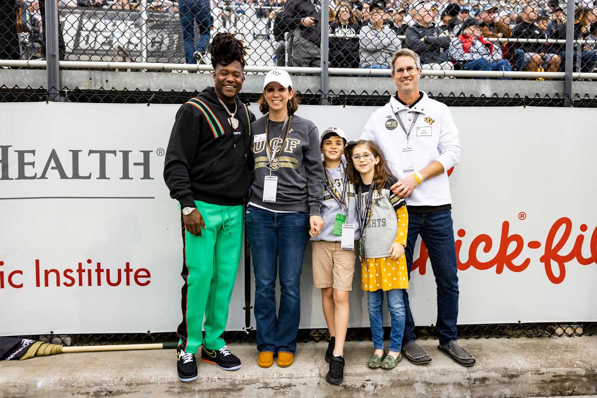 Darin Edwards, his wife and two children pose with Shaquem Griffin at football stadium