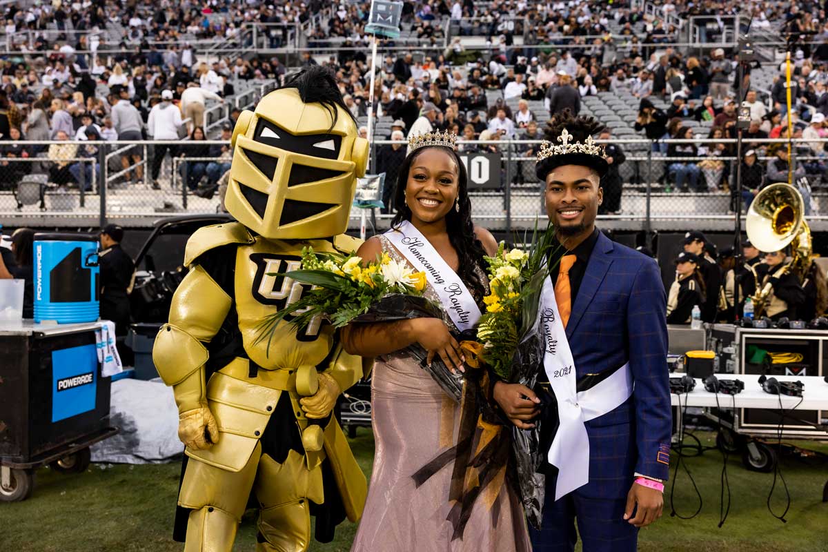 Knightro stands with this year's Homecoming queen and king