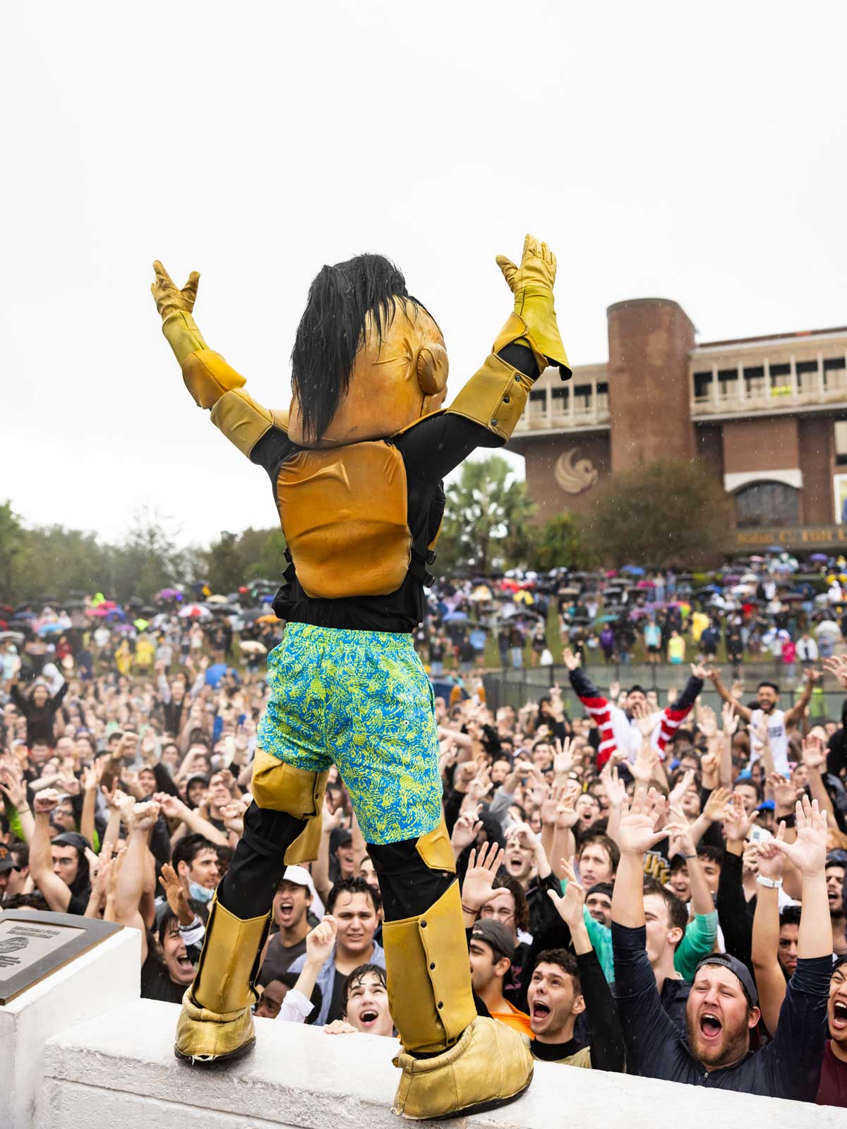 Knightro in board shorts energizes crowd after rushing the Reflecting Pond at Spirit Splash