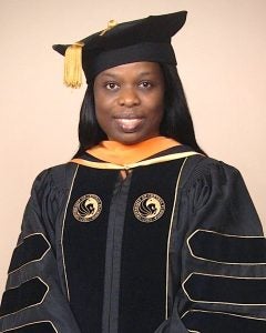 Eunice Ojo wearing doctoral graduation attire.