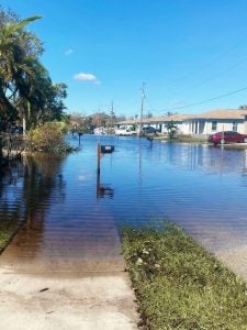 A flooded street near homes