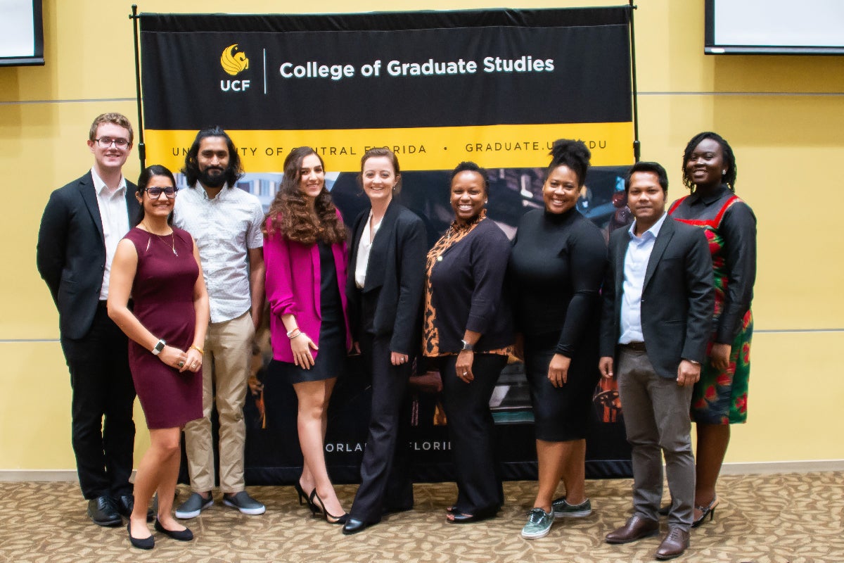 A group of doctoral students presenting at the Three Minute Thesis Competition.