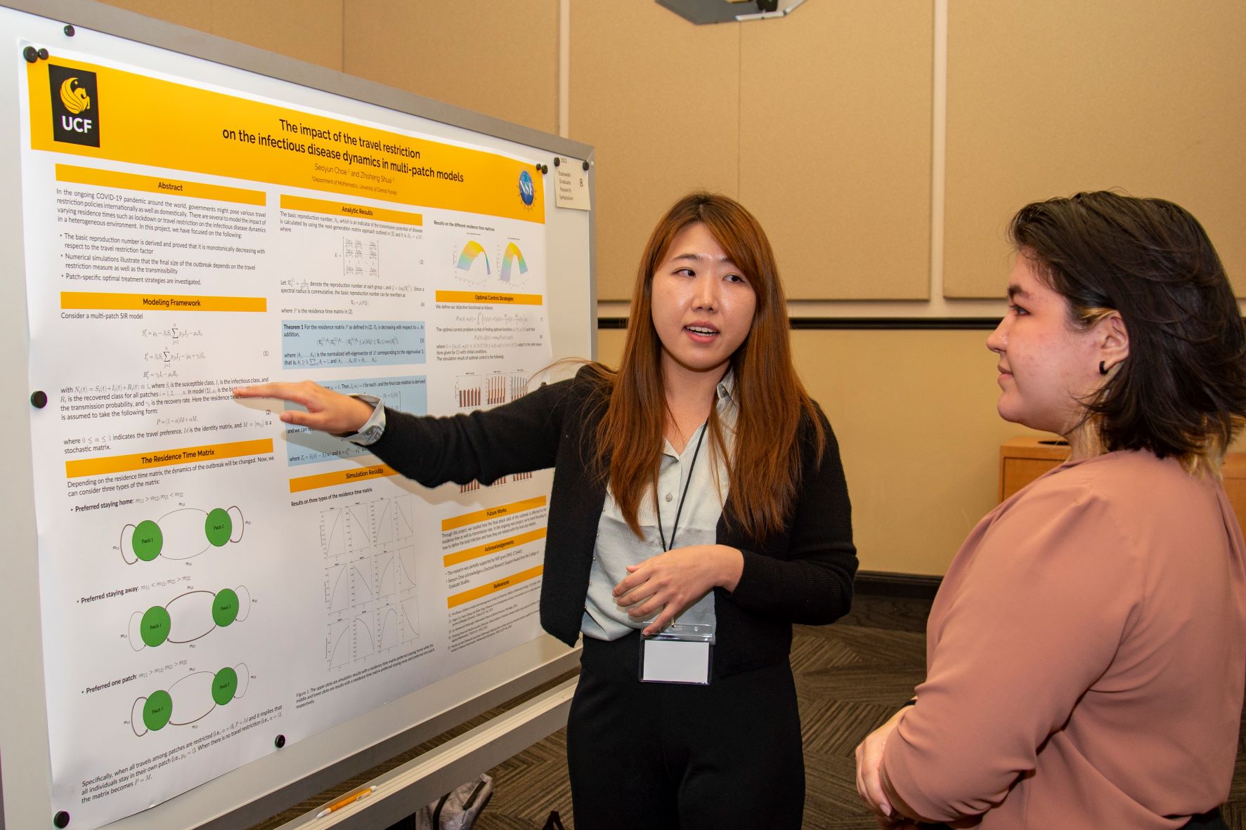 Student presenting at the student scholar symposium to a judge.