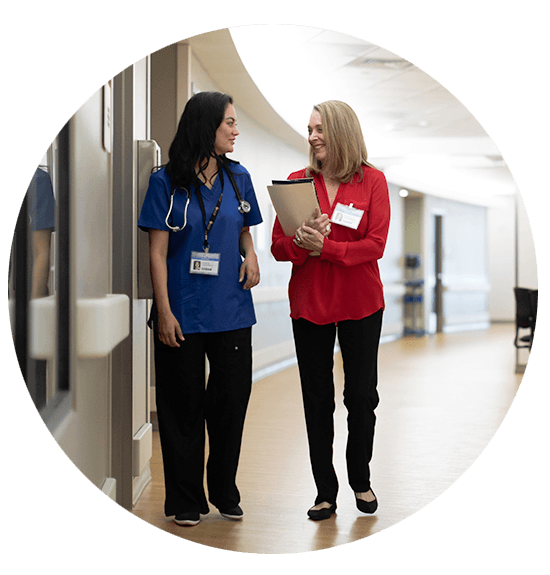 Nurse and Admin walking down a hall