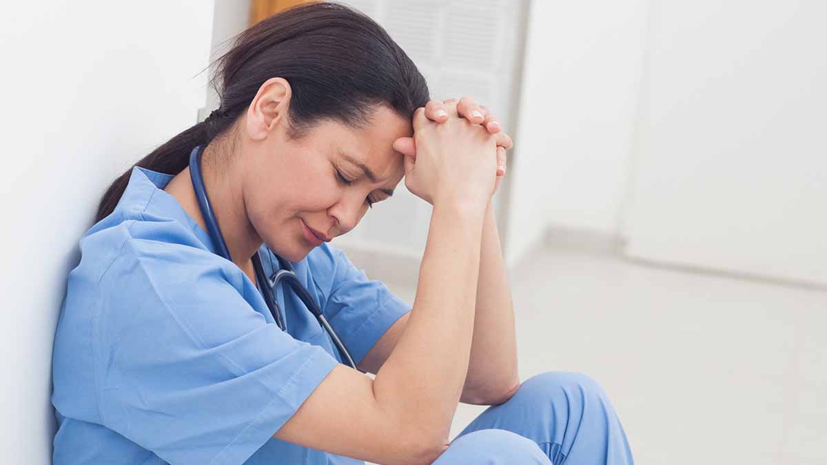 Female Nurse crying in the corner