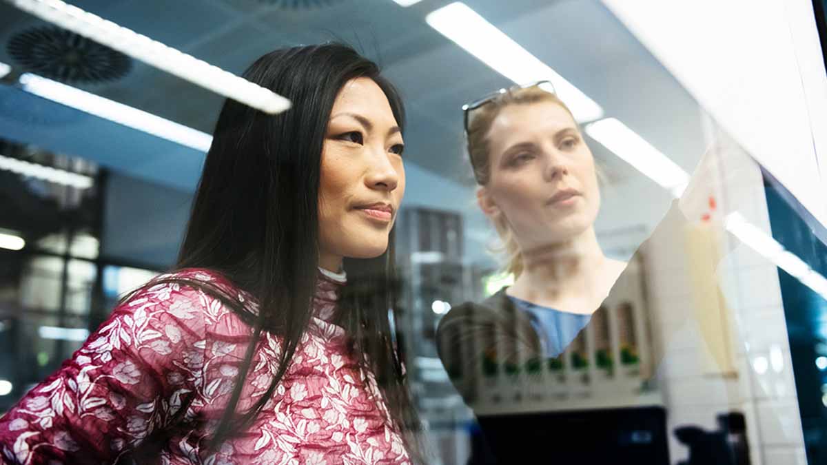 Engineer looking at data through a transparent medium.